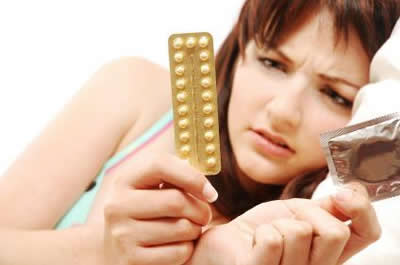 Una donna alle prese con delle pillole anticoncezionali